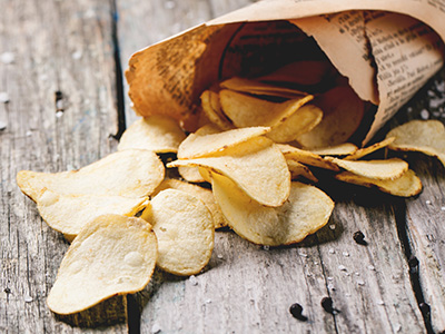 A bag of potato chips spilled out on the table